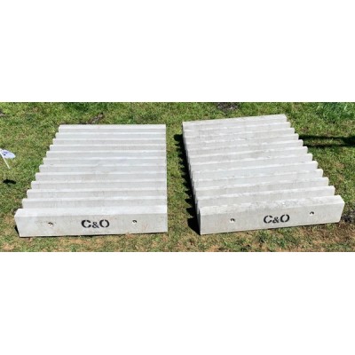 Two ridged concrete cattle stop blocks stamped C&O on grass