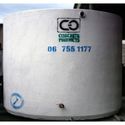 Large cylindrical concrete water tank stamped C&O