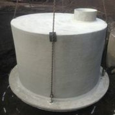 Concrete dairy chill tank being lowered into place with chains