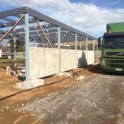 Precast concrete wall panels being erected at a cowshed build